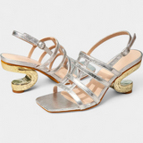 Deborah Spīdīgas Metāla Sandales" can be rewritten as "Deborah Shiny Metal Sandals.